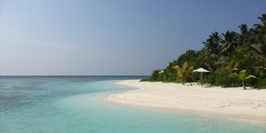 A beach with white sand and blue water