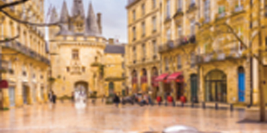 A blurry image of people walking on the street.