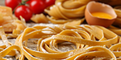 A close up of pasta and tomatoes on the table