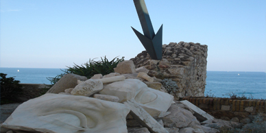 A rock pile with a metal sculpture in the foreground.