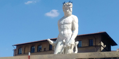 A statue of a man with horns on his head.