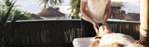 A woman is getting her head washed by a masseuse.